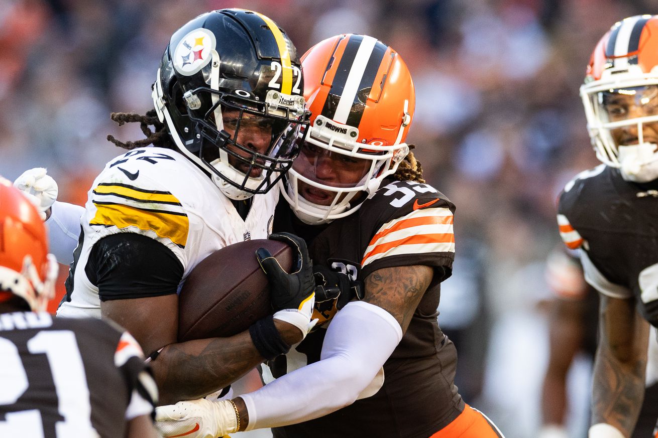 Pittsburgh Steelers running back Najee Harris collides with Cleveland Browns safety Ronnie Hickman during a 2023 regular season contest from Cleveland Browns Stadium.