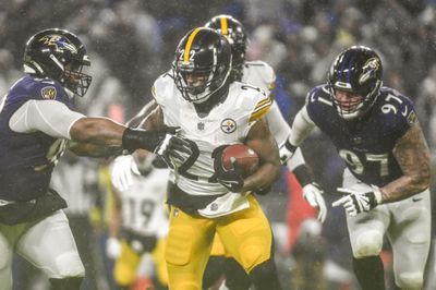 Pittsburgh Steelers running back Najee Harris bolts through Baltimore Ravens defenders during a 2023 divisional contest.