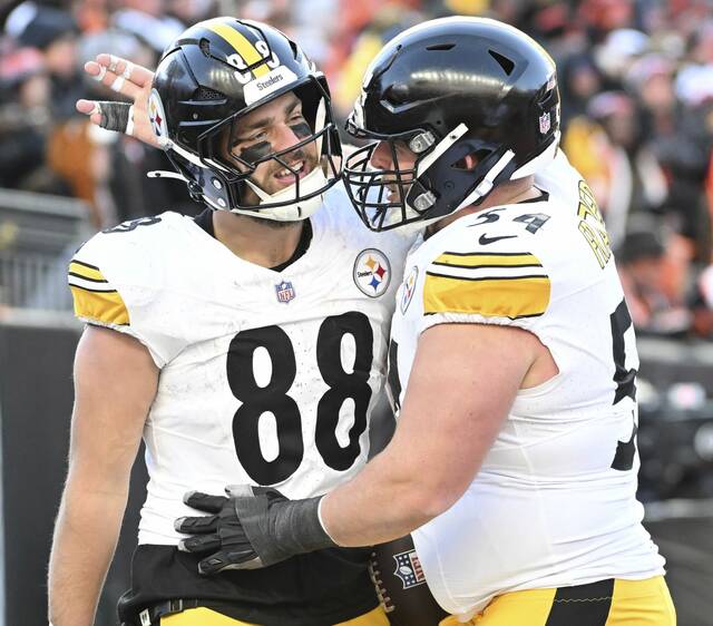 Pittsburgh Steelers center Zach Frazier celebrates with tight end Pat Freiermuth after Freiermuth’s touchdown against the Cincinnati Bengals in the third quarter Sunday, Dec. 1, 2024, at Paycor Stadium.