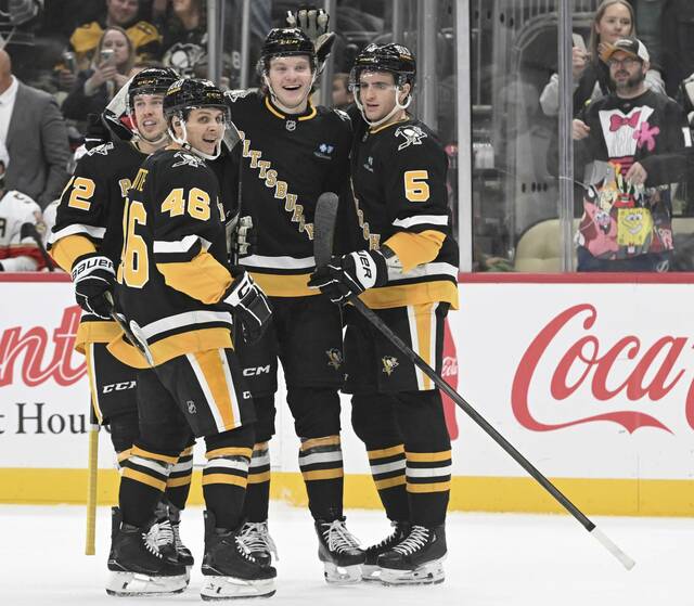 The Penguins’ celebrate Owen Pickering’s first NHL goal against the Panthers in the first period Tuesday.