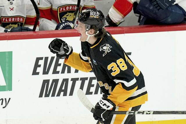 Pittsburgh Penguins’ Owen Pickering celebrates as he returns to the bench after scoring during the first period of an NHL hockey game against the Florida Panthers, Tuesday, Dec. 3, 2024, in Pittsburgh. (AP Photo/Matt Freed)