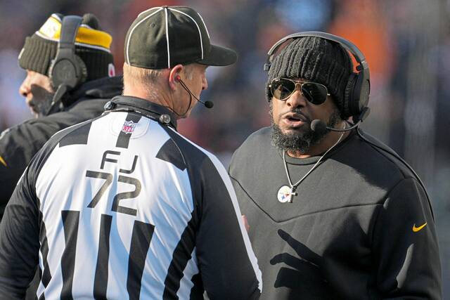 Pittsburgh Steelers coach Mike Tomlin speaks with an official during an NFL football game against the Cincinnati Bengals Sunday, Dec. 1, 2024, in Cincinnati.