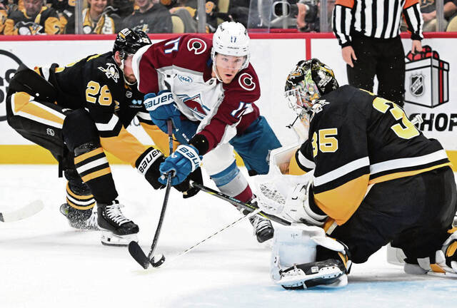 Penguins goaltender Tristan Jarry makes a stick save on the Avalanches’ Parker Kelly in the second period Tuesday at PPG Paints Arena.