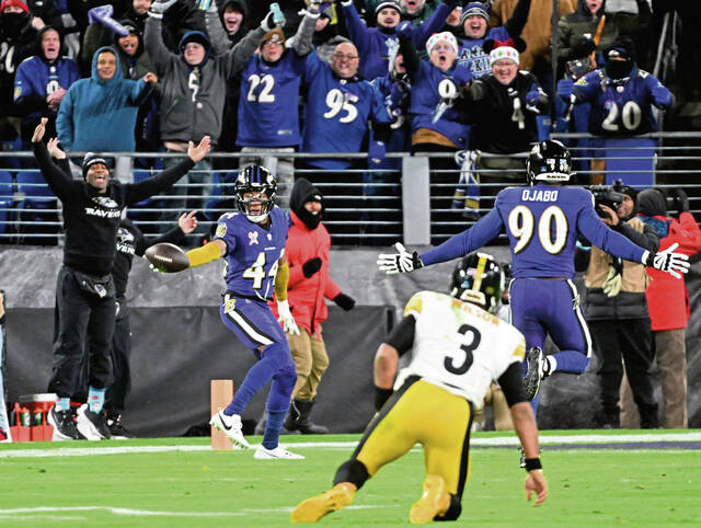 Steelers quarterback Russell Wilson can only watches as the Ravens’ Marlon Humphrey returns an interception for a fourth-quarter touchdown Saturday at M&T Bank Stadium.