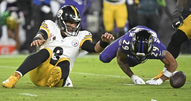 The Ravens’ Ar’Darius Washington causes Steelers quarterback Russell Wilson to fumble in the second quarter Saturday at M&T Bank Stadium.