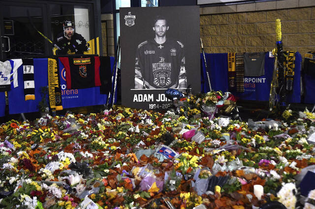 Flower tributes for Nottingham Panthers player Adam Johnson rest outside the Motorpoint Arena before a memorial ice hockey game between Nottingham Panthers and Manchester Storm in Nottingham, England, Nov. 18, 2023.