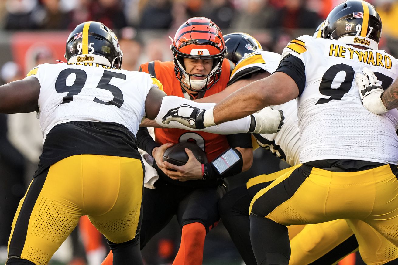 Pittsburgh Steelers defenders swarm Cincinnati Bengals quarterback Joe Burrow during a 2024 regular season tilt from Paycor Stadium in Cincinnati. 