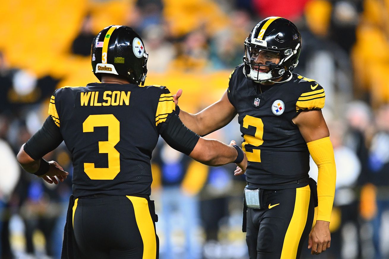 Russell Wilson #3 talks with Justin Fields #2 of the Pittsburgh Steelers prior to the game agnate the New York Giants at Acrisure Stadium on October 28, 2024 in Pittsburgh, Pennsylvania.