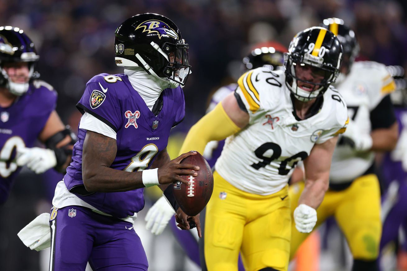 Lamar Jackson #8 of the Baltimore Ravens looks to pass while pressured bt T.J. Watt #90 of the Pittsburgh Steelers during the second quarter at M&T Bank Stadium on December 21, 2024 in Baltimore, Maryland.