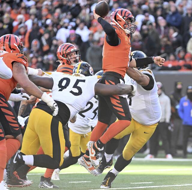 The Steelers’ Keeanu Benton and Cameron Heyward pressure the Bengals’ Joe Burrow in the second quarter Sunday, Dec. 1, 2024, at Paycor Stadium.