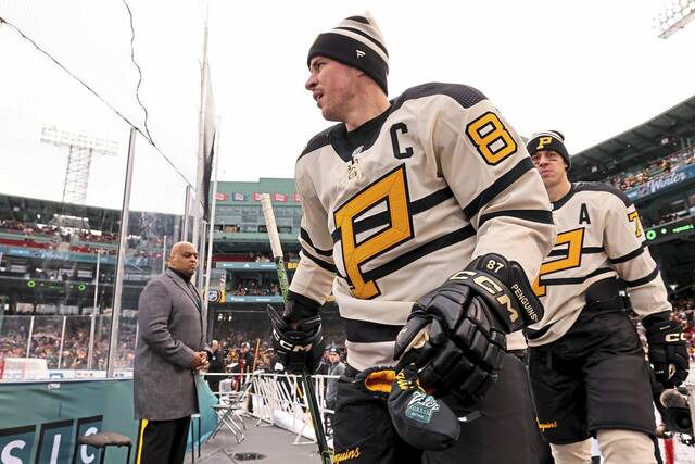 Sidney Crosby (87) and Evgeni Malkin of the Pittsburgh Penguins take the ice prior to playing the Boston Bruins in the 2023 Discover NHL Winter Classic on Jan. 2, 2023, at Fenway Park in Boston, Mass.