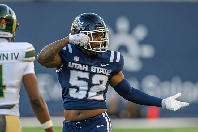 Utah State defensive end Blaine Spires (52) celebrates a tackle during an NCAA football game on Saturday, Oct. 7, 2023 in Logan, Utah.