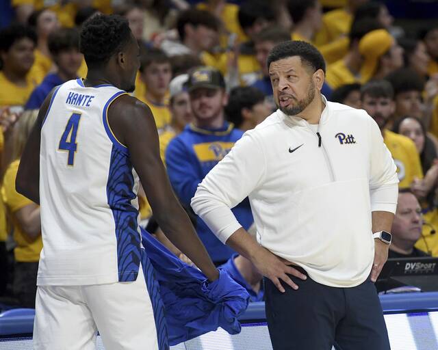 Pitt coach Jeff Capel talks with Papa Amadou Kante during a game against Radford on Nov. 4, 2024, at Petersen Events Center.