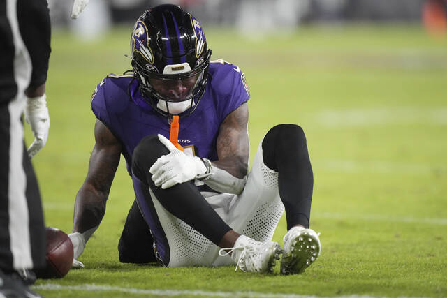 Baltimore Ravens wide receiver Zay Flowers grabs his leg after being injured during the first half of Saturday’s regular-season finale against the Cleveland Browns. Flowers could miss this coming Saturday’s playoff game against the Pittsburgh Steelers.