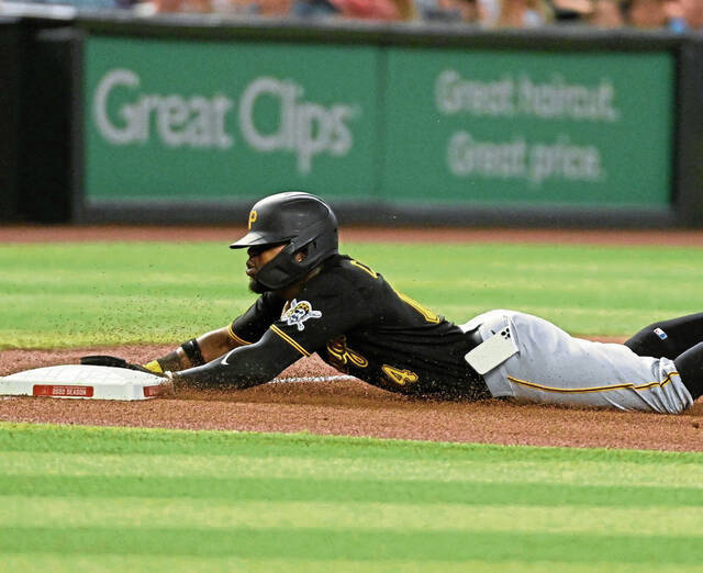 Pirates infielder Rodolfo Castro slides into third base as his cellphone falls out of his pocket in the fourth inning of a game against the Arizona Diamondbacks at Chase Field on Aug. 9, 2022, in Phoenix.