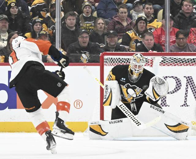 Penguins goaltender Tristan Jarry makes a first-period glove save on the Flyers’ Scott Laughton on Dec. 23, 2024 at PPG Paints Arena.