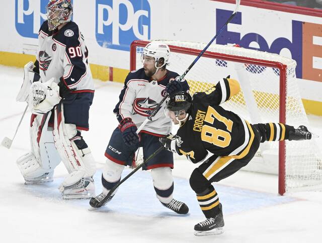 The Penguins’ Sidney Crosby battles for position in front of the net as the Blue Jackets’ Jake Christiansen defends in the first period Tuesday.