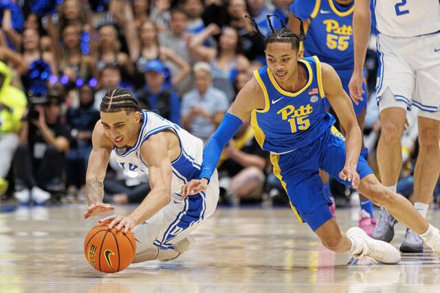 Duke’s Tyrese Proctor, left, and Pitt’s Jaland Lowe dive for a loose ball during the first half Tuesday.