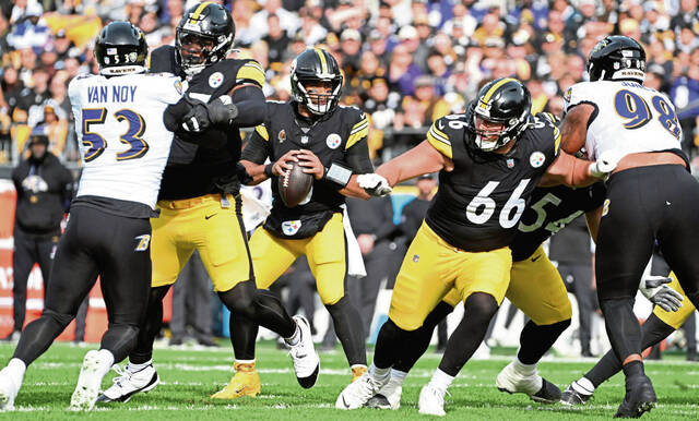 Steelers offensive linemen Broderick Jones and Mason McCormick (66) block for Russell Wilson against the Baltimore Ravens in the first quarter Sunday Nov. 17, 2024 at Acrisure Stadium.