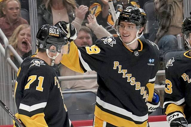 Penguins forward Cody Glass, right, celebrates with Evgeni Malkin after scoring against the Colorado Avalanche on Dec. 10, 2024.