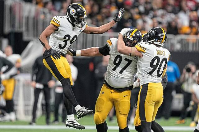 Steelers safety Minkah Fitzpatrick, defensive tackle Cameron Heyward and linebacker T.J. Watt celebrate sacking Falcons quarterback Marcus Mariota in the Dec. 4, 2022, game in Atlanta.