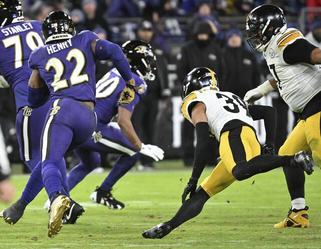 Ravens running back Derrick Henry turns the corner on the Steelers’ Minkah Fitzpatrick and Cam Heyward for his longest run of the day in the fourth quarter Dec. 21, 2024 at M&T Bank Stadium.