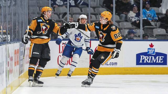 Wilkes-Barre/Scranton Penguins forward Ville Koivunen (left) and defenseman Filip Kral celebrate a goal during a game against the Toronto Marlies at the Coca-Cola Coliseum in Toronto on Wednesday. The Penguins won, 6-3.