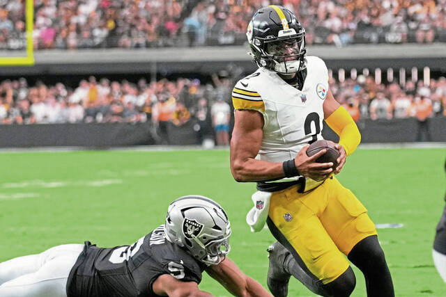 Steelers quarterback Justin Fields runs for a touchdown past Raiders defensive end Tyree Wilson in the first half of the Oct. 13 game in Las Vegas.