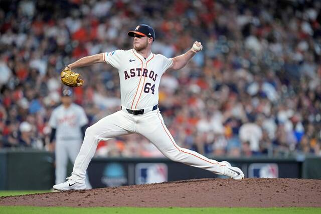 Houston Astros pitcher Caleb Ferguson throws during the eighth inning of Game 1 of an AL Wild Card Series baseball game against the Detroit Tigers, Tuesday, Oct. 1, 2024, in Houston.