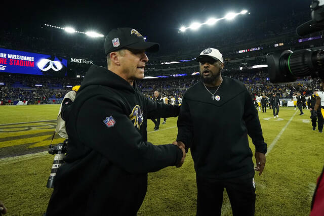 Baltimore Ravens coach John Harbaugh meets with Pittsburgh Steelers coach Mike Tomlin a Jan. 1, 2023, game in Baltimore. Saturday, the coaches will face each other in a playoff game for the fifth time.