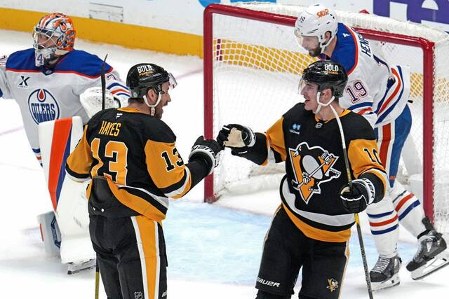 Pittsburgh Penguins’ Kevin Hayes (13) celebrates his goal with Drew O’Connor during the first period of an NHL hockey game against the Edmonton Oilers in Pittsburgh, Thursday, Jan. 9, 2025. (AP Photo/Gene J. Puskar)