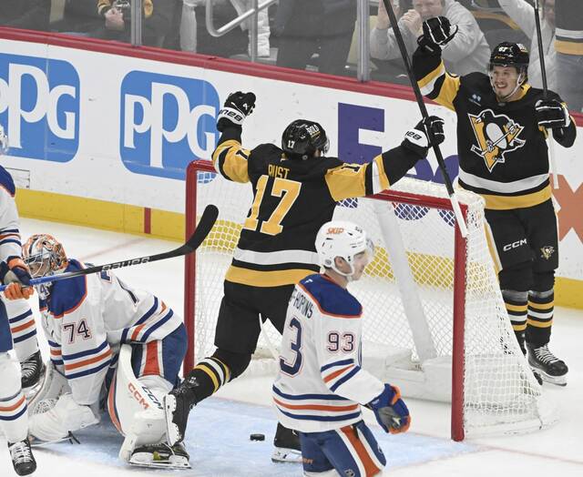 The Penguins’ Bryan Rust celebrates with Rickard Rakell after Rakell’s goal against the Oilers in the first period Thursday at PPG Paints Arena.