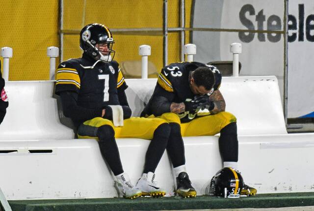 Pittsburgh Steelers quarterback Ben Roethlisberger sits on the bench with teammate Maurkice Pouncey, a center, following a 48-37 loss to the Cleveland Browns in a Jan. 10, 2021, playoff game in Pittsburgh. The Steelers trailed 28-0 after one quarter that day.