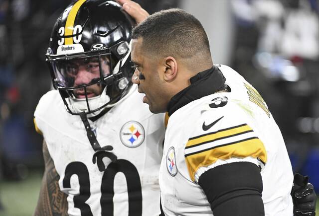 Pittsburgh Steelers quarterback Russell Wilson consoles running back Jaylen Warren after Saturday night’s loss to the Baltimore Ravens in an AFC Wild Card game at M&T Bank Stadium.