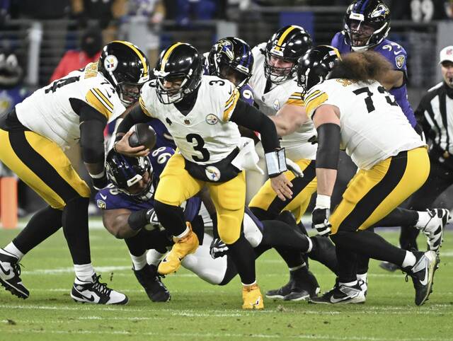 Steelers quarterback Russell Wilson takes off and runs against the Ravens in the first quarter during the AFC Wild Card game Saturday Jan. 11, 2025 at M&T Bank Stadium.