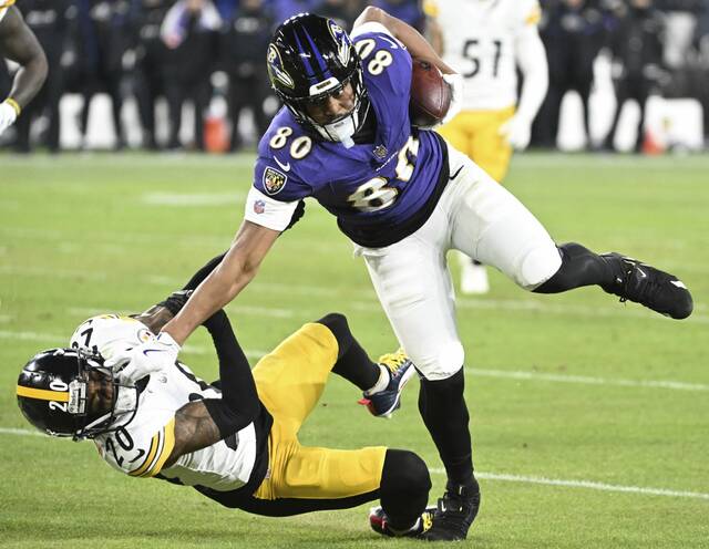 The Ravens’ Isaiah Likely stiff-arms the Steelers’ Cameron Sutton to the ground in the second quarter during the AFC Wild Card Saturday Jan. 11, 2025 at M&T Bank Stadium.