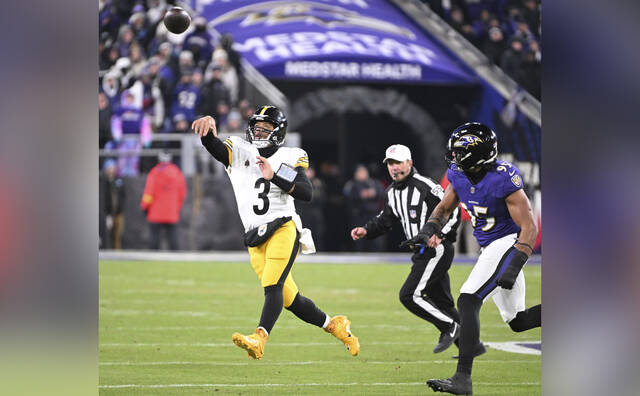 Steelers quarterback Russell Wilson throws the ball away Saturday against the Ravens in the AFC Wild Card game at M&T Bank Stadium in Baltimore.