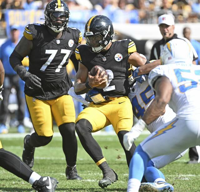 Steelers quarterback Justin Fields gets sacked by the Chargers’ Tuli Tuipulotu in the third quarter Sept. 22, 2024 at Acrisure Stadium.