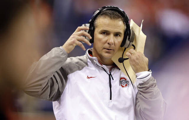 Ohio State head coach Urban Meyer watches from the sidelines during the second half of the Big Ten Conference championship NCAA college football game against Wisconsin Saturday, Dec. 6, 2014, in Indianapolis.