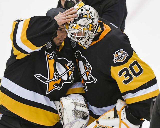 Penguins goalie Marc-Andre Fleury (29) congratulates Penguins goalie Matt Murray (30) on a 6-0 shutout against the Predators in Game 5 of the NHL Stanley Cup Finals on June 8, 2017 at PPG Paints Arena.