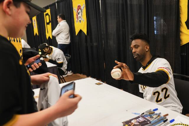 The Pirates’ Andrew McCutchen gives a signed baseball back to a fan Saturday during PiratesFest at David L. Lawrence Convention Center.