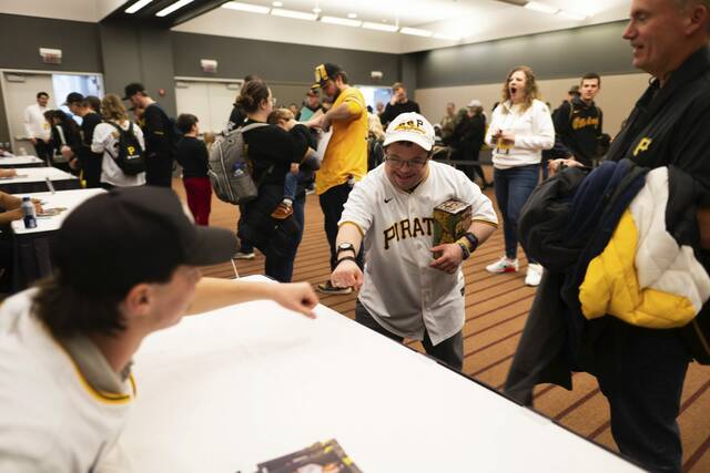 Evan Peel, of North Strabane, with his father John Peel, at right, gets excited as his fist bumps Pittsburgh Pirates player Bubba Chandler on Saturday, Jan. 18, 2025 during PiratesFest at the David L. Lawrence Convention Center in Downtown Pittsburgh.