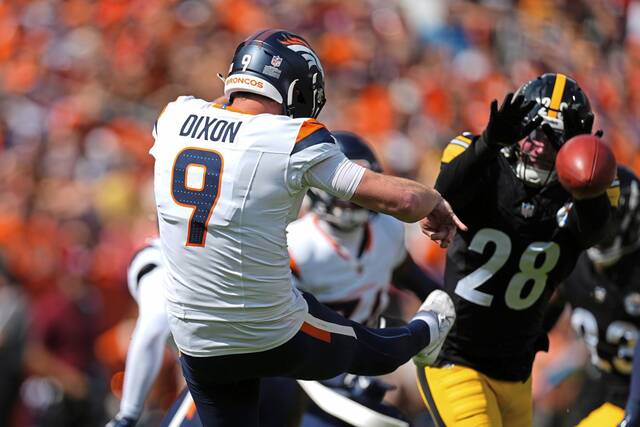 Denver Broncos punter Riley Dixon (9) punts against Pittsburgh Steelers safety Miles Killebrew (28) during the first half of an NFL football game, Sunday, Sept. 15, 2024, in Denver.