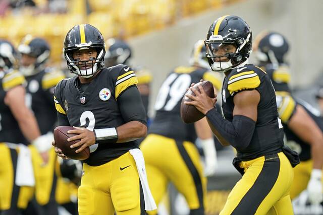 Steelers quarterbacks Russell Wilson (left) and Justin Fields warm up before an exhibition game against the Buffalo Bills on Aug. 17 in Pittsburgh.