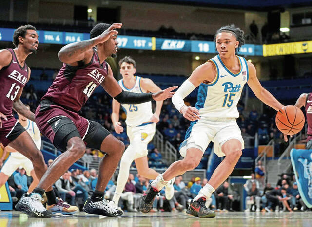 Pitt’s Jaland Lowe handles the ball as Eastern Kentucky’s Devontae Blanton defends Wednesday, Dec. 11, 2024.