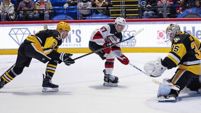 Wilkes-Barre/Scranton Penguins defenseman Jack. St. Ivany and goaltender Tristan Jarry defend Utica Devils foward Xavier Parent during a game at the Adirondack Bank Center in Utica, N.Y. on Friday. The Comets won, 5-3.