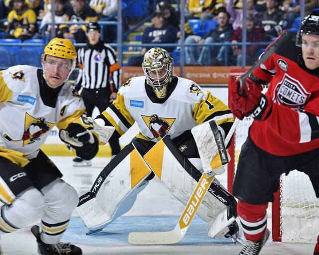 Wilkes-Barre/Scranton Penguins goaltender Sergei Murashov defends his net behind Penguins defenseman Dan Renouf and Utica Comets forward Mike Hardman during a game at Mohegan Sun Arena in Wilkes-Barre on Saturday. The Penguins won, 2-1.