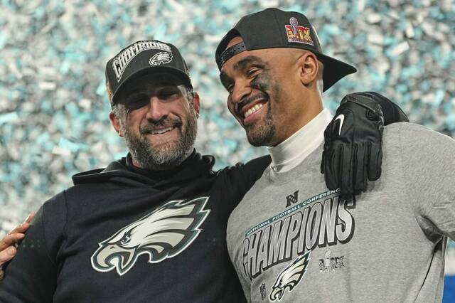 Eagles coach Nick Sirianni (left) and quarterback Jalen Hurts celebrate Sunday after winning the NFC Championship game against the Washington Commanders in Philadelphia.