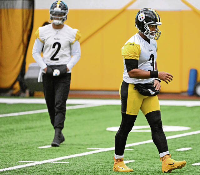 Steelers quarterback Justin Fields looks on as Russell Wilson works during practice Wednesday Oct. 16, 2024 at UPMC Rooney Sports Performance Complex.