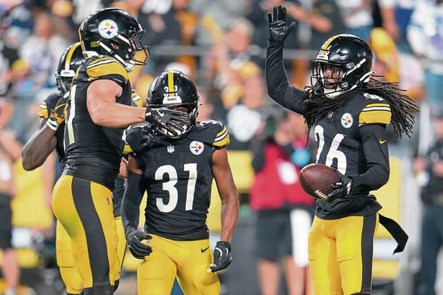 Pittsburgh Steelers cornerback Donte Jackson (26) reacts with teammates after intercepting a pass thrown by Dallas Cowboys quarterback Dak Prescott during the first half of an NFL football game, Sunday, Oct. 6, 2024, in Pittsburgh.